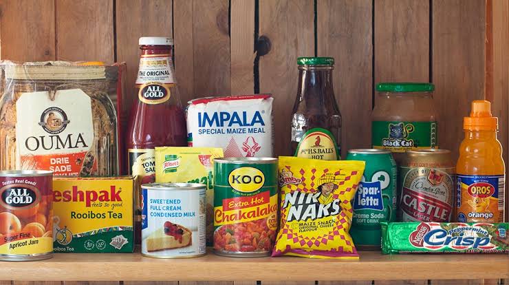 Shelves of pantry staples — tinned goods, tea, sauces and snacks